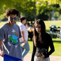 Students grabbing giveaway bags on Kirkhof Lawn.